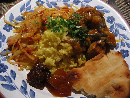 yellow rice, cabbage, lamb and eggplant stew, bread and pickles